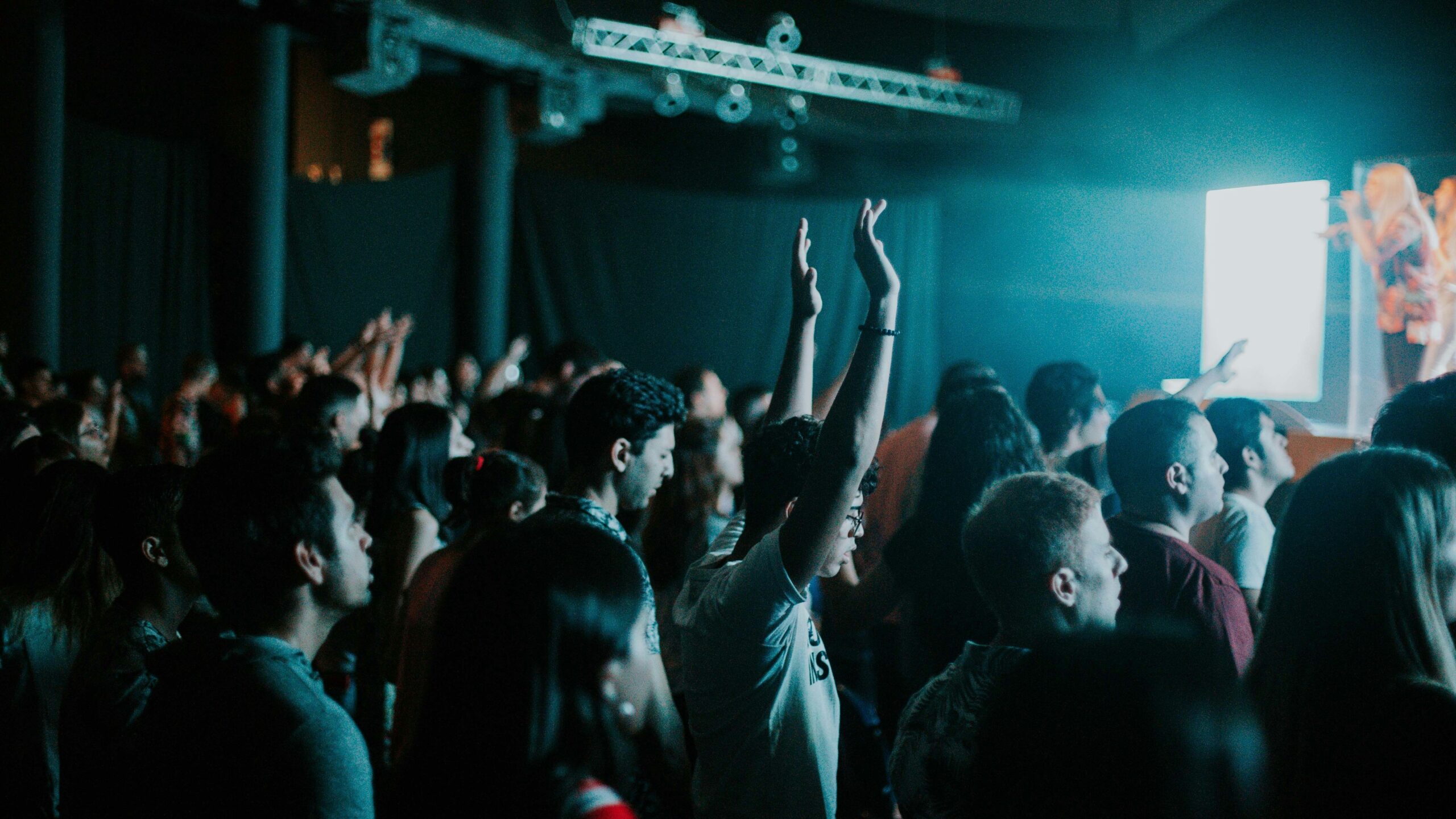 people raising their hands in front of people