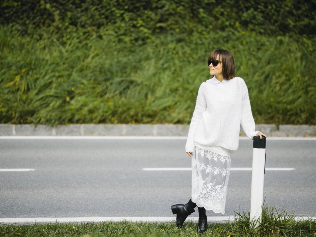 Model blending vintage lace skirt with a modern knit sweater, striking a pro balance of vintage and modern styles in 2025 fashion.