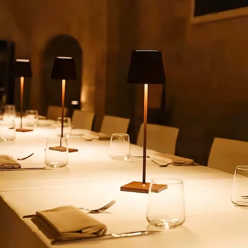 The Cordless Table Lamps (Bright and Eco-Friendly Light) sits on a dining table at a luxury restaurant.