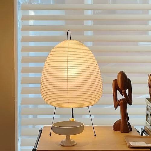 A Traditional Japanese Lamp on the table with other decor items.